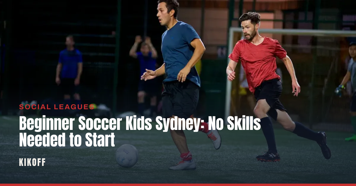 A small group of young beginner players in bibs following a coach's instructions on a caged five-a-side pitch.