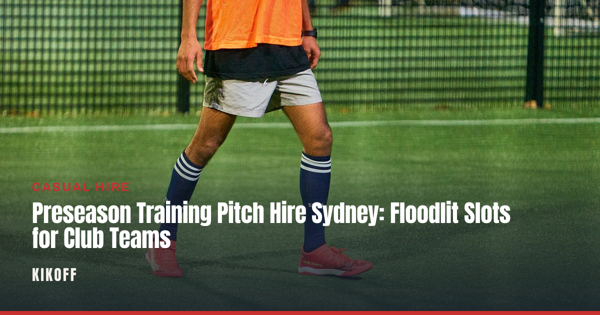 A club football team training under floodlights on a caged synthetic pitch at night