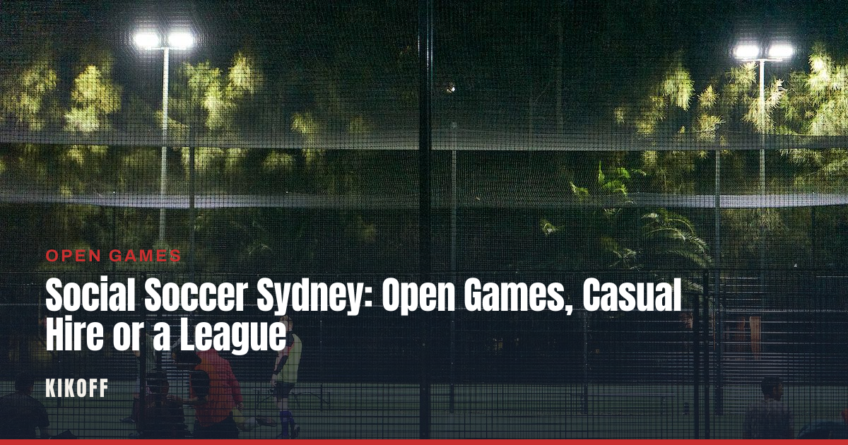 A group of adult players in mixed kit playing small-sided football under floodlights on a synthetic pitch at dusk