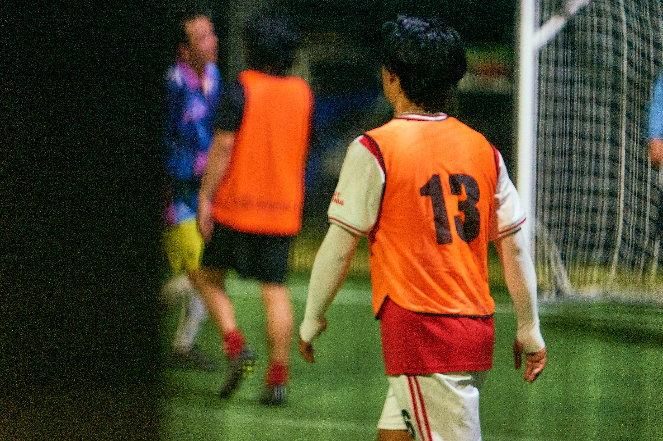 Two teams lining up before a Wednesday night 5-a-side game under the lights at KIKOFF Northern Beaches.